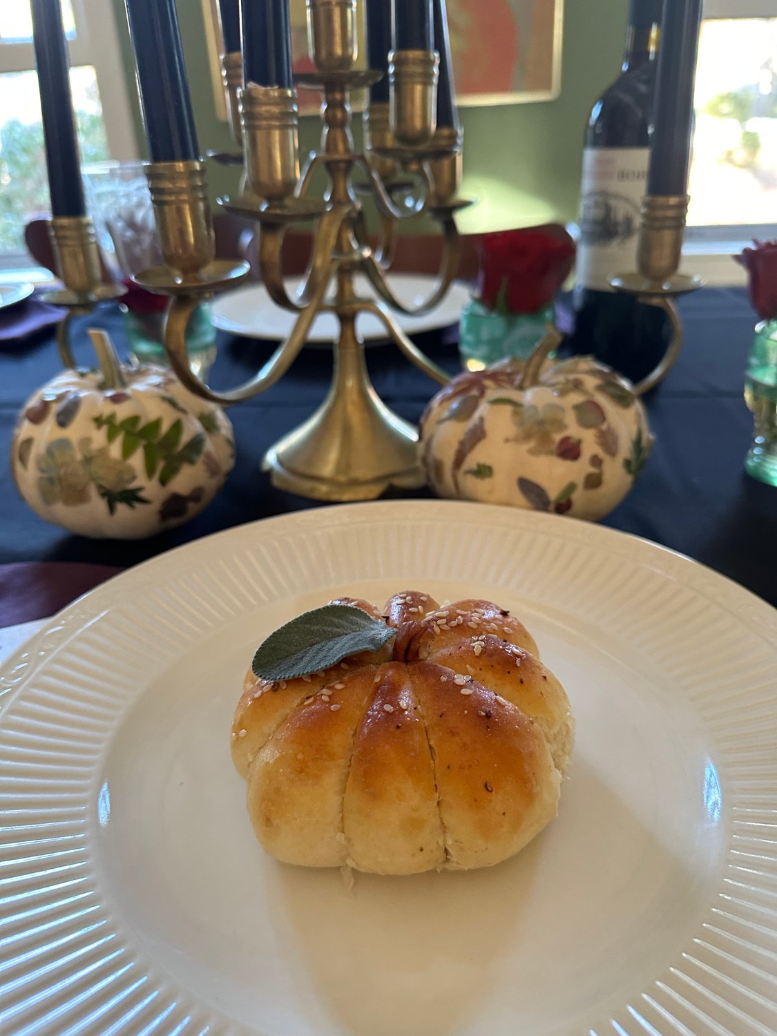 Pumpkin-shaped dinner roll on a plate